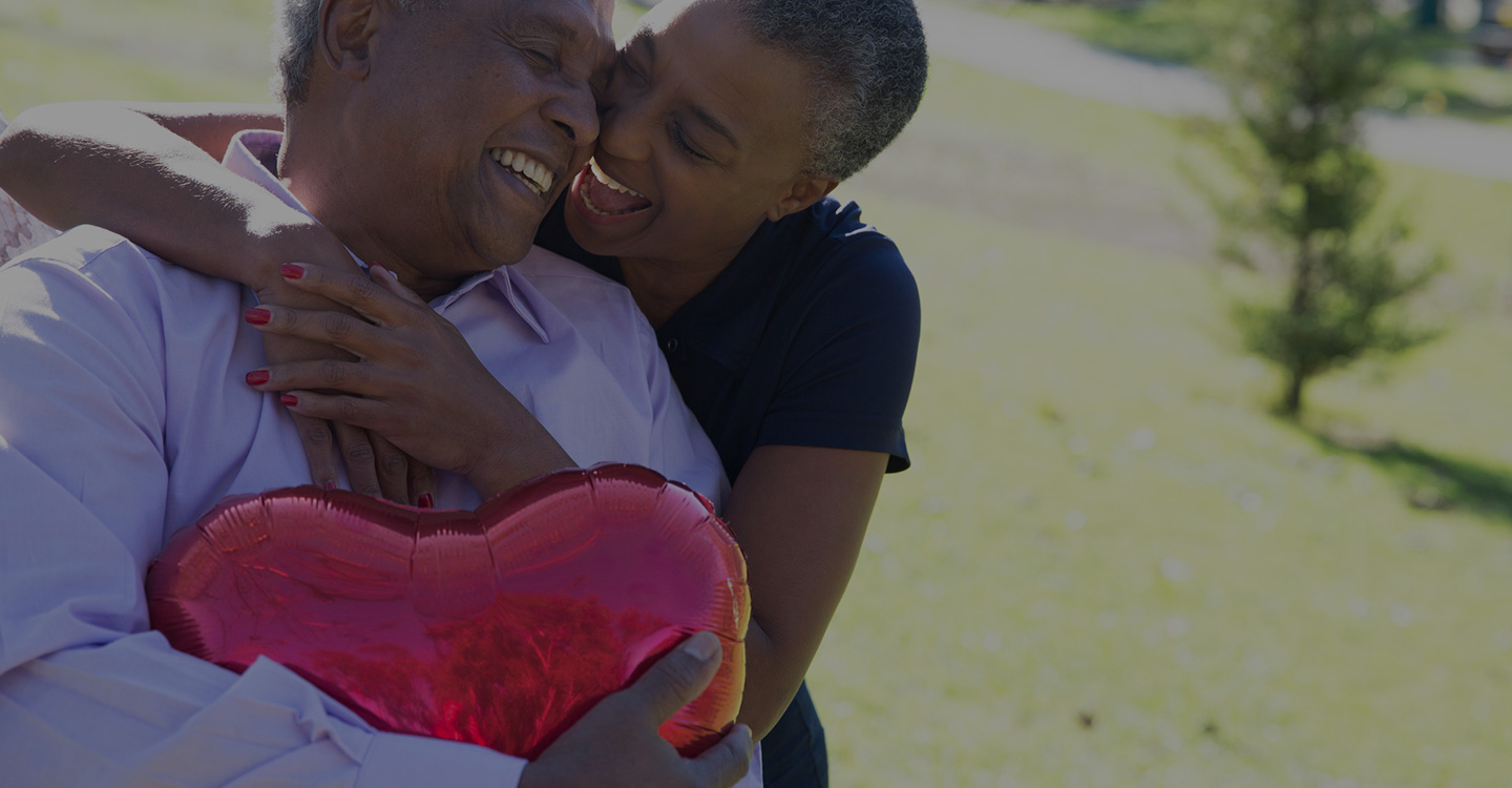 A couple embracing outside at a park