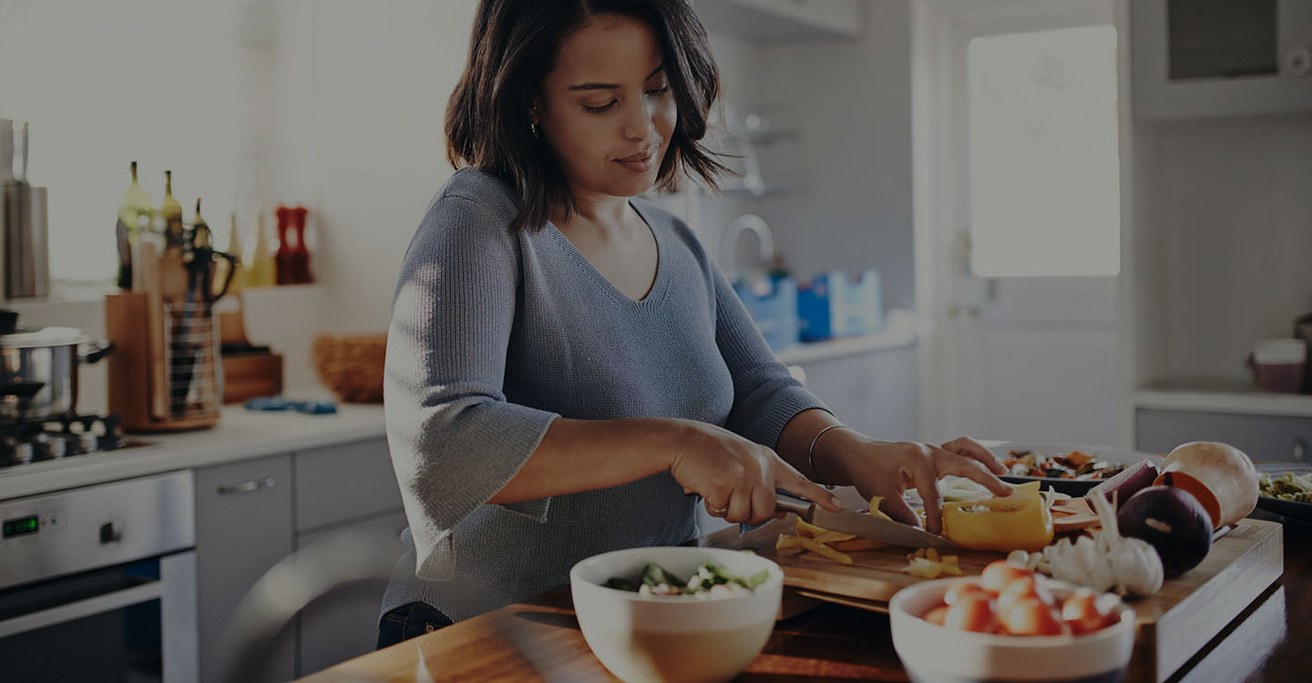 A woman preparing a healthy meal to manage her diabetes