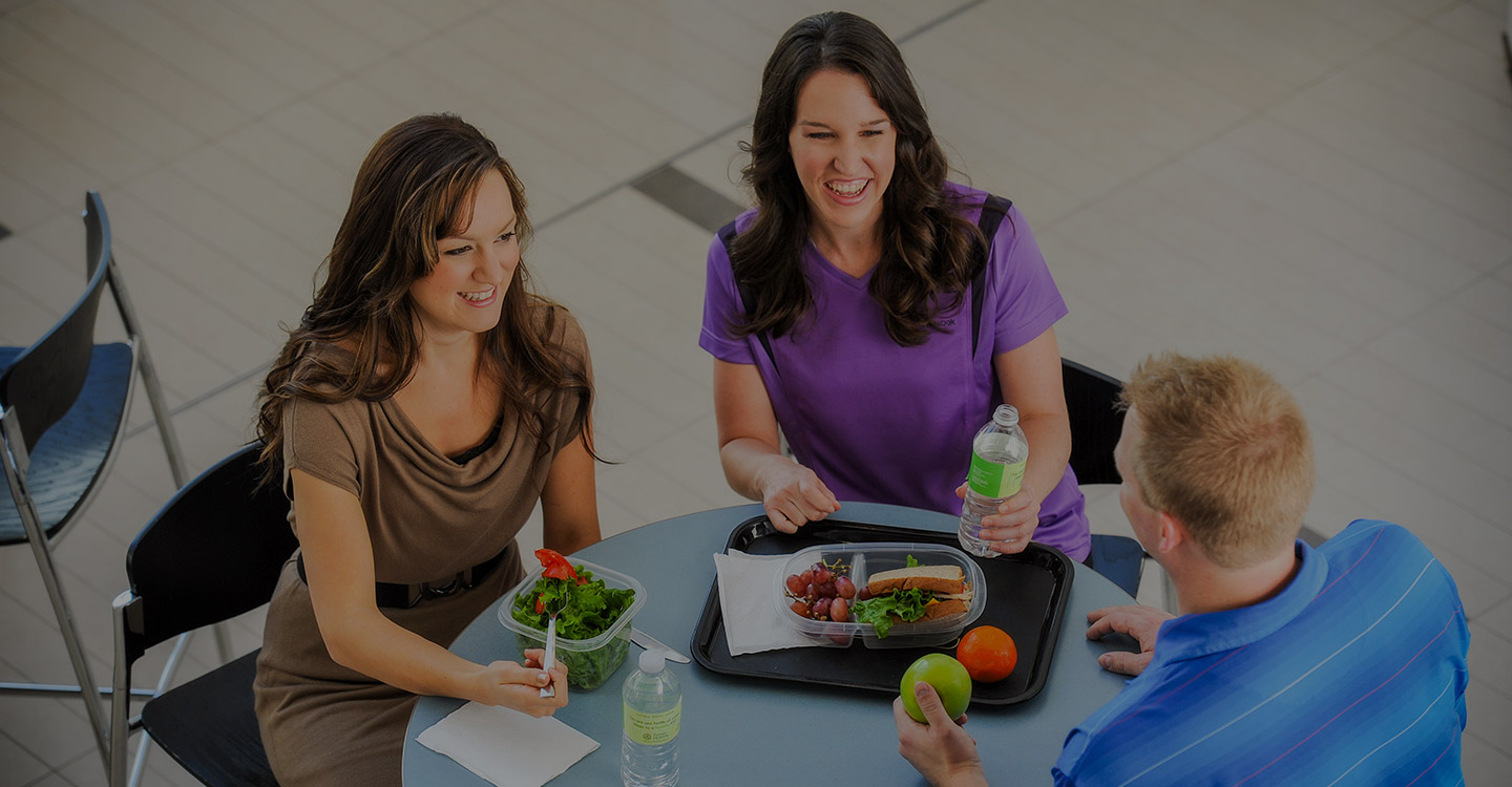 Coworkers enjoying a healthy meal together on their lunch break