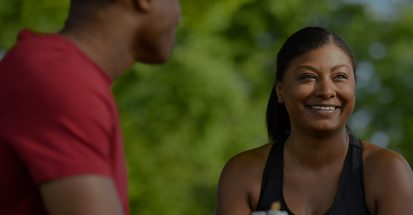 Two patients with metabolic and endocrine disorders smiling while outdoors and wearing exercise attire