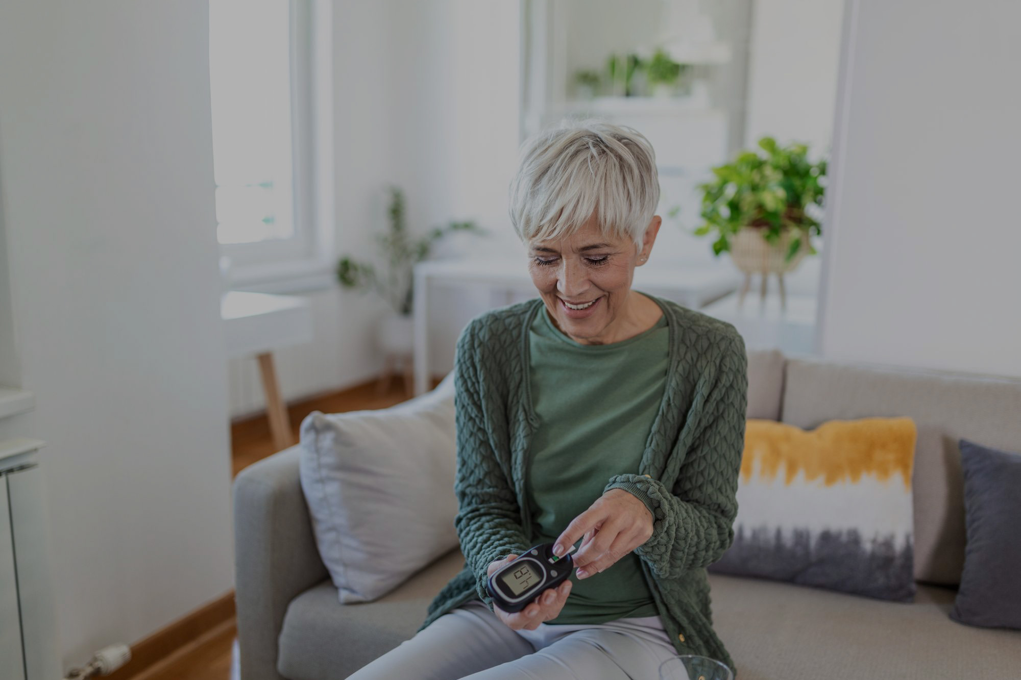 Older woman checking her blood sugar level